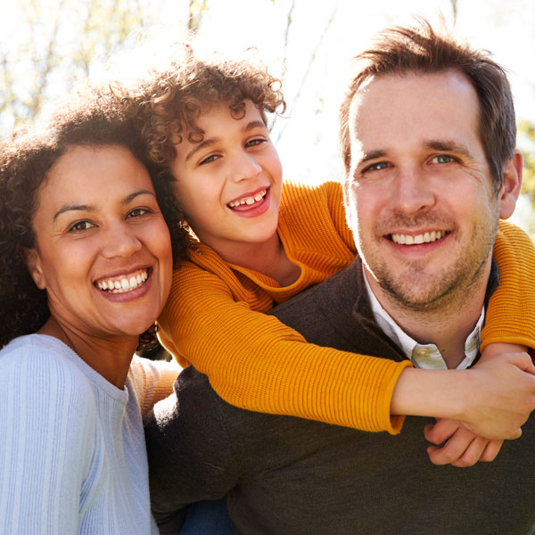 Family smiling together after a visit to Family Dental Care
